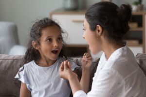 Pediatric Speech Therapist Working with a Child at Their House