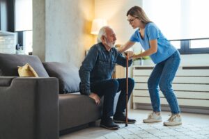 Daughter Helping Her Stroke Patient Father Stand