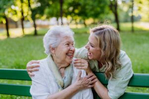 Adult laughing with her Grandmother when she sitting