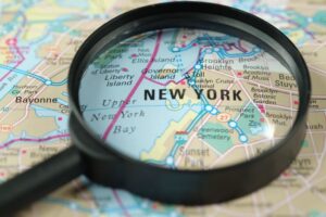 A Close-up of a map of New York City with a magnifying glass.